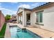 Relaxing backyard with a small pool and covered patio seating area at 2169 N 212Th Ln, Buckeye, AZ 85396