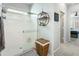 Bathroom featuring a glass-enclosed shower, shelving, and decorative accents at 2169 N 212Th Ln, Buckeye, AZ 85396