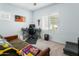 Comfortable bedroom featuring a desk, gaming setup, and cozy seating at 2169 N 212Th Ln, Buckeye, AZ 85396