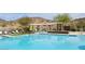 Stunning community pool featuring lounge chairs, umbrellas and mountain views at 2169 N 212Th Ln, Buckeye, AZ 85396
