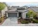 Charming home featuring a well-manicured lawn, two-car garage, and delightful curb appeal at 2169 N 212Th Ln, Buckeye, AZ 85396