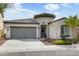 Home featuring a two-car garage, a well-kept front yard, and a lovely front entrance at 2169 N 212Th Ln, Buckeye, AZ 85396