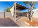 Inviting backyard featuring a covered patio area with a fire pit and mature landscaping at 2581 E Commonwealth Cir, Chandler, AZ 85225