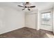 Carpeted bedroom offers neutral paint, a closet, and a window for natural lighting at 2581 E Commonwealth Cir, Chandler, AZ 85225