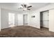Carpeted bedroom with fan, closet, and attached bathroom at 2581 E Commonwealth Cir, Chandler, AZ 85225