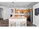 The kitchen is features a kitchen island, wooden cabinets, and stainless steel appliances at 28321 N Zircon Dr, San Tan Valley, AZ 85143