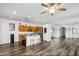 Open-concept kitchen featuring a breakfast bar, stainless steel appliances, and wood cabinetry at 28321 N Zircon Dr, San Tan Valley, AZ 85143