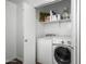 Laundry room includes a white washer and dryer, shelves, and a white door at 28321 N Zircon Dr, San Tan Valley, AZ 85143