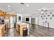 Open concept living room featuring wood floors, kitchen island, and plenty of natural light at 28321 N Zircon Dr, San Tan Valley, AZ 85143