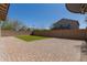 Spacious backyard with stone pavers and a rectangular patch of well-kept green lawn at 2943 W Thorn Tree Dr, Phoenix, AZ 85085