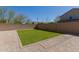 Well manicured backyard featuring a lush green lawn area surrounded by brick and gravel at 2943 W Thorn Tree Dr, Phoenix, AZ 85085