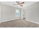 This bedroom features neutral walls, carpet and a ceiling fan at 2943 W Thorn Tree Dr, Phoenix, AZ 85085