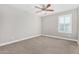 This bedroom features neutral walls, carpet and a ceiling fan at 2943 W Thorn Tree Dr, Phoenix, AZ 85085