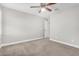 Neutral carpeted bedroom featuring a ceiling fan, recessed lighting, and open closet at 2943 W Thorn Tree Dr, Phoenix, AZ 85085