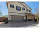 Two-story home features a two-car garage, neutral stucco, and a brick-paved driveway and walkway at 2943 W Thorn Tree Dr, Phoenix, AZ 85085