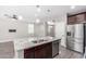 Open-concept kitchen features an island with seating and stainless appliances at 2943 W Thorn Tree Dr, Phoenix, AZ 85085