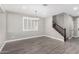 Living room featuring modern flooring, natural light, and an elegant light fixture at 2943 W Thorn Tree Dr, Phoenix, AZ 85085