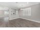 A spacious living area with wood-look flooring, neutral paint, and an open-concept layout at 2943 W Thorn Tree Dr, Phoenix, AZ 85085