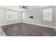 Living room with wood floors, ceiling fan, and plantation shutters at 2943 W Thorn Tree Dr, Phoenix, AZ 85085
