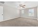 A bright main bedroom features a ceiling fan and abundant windows at 2943 W Thorn Tree Dr, Phoenix, AZ 85085