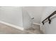 Stairway with wood railing and neutral carpet at 2943 W Thorn Tree Dr, Phoenix, AZ 85085
