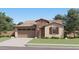 Charming single-story home featuring a stone facade, attached two-car garage, and inviting front lawn at 3396 E Open Prairie Dr, San Tan Valley, AZ 85140