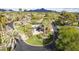 Stunning aerial view of a meticulously landscaped home with mature palm trees, set against a backdrop of mountain views at 345 W Gardenia Dr, Phoenix, AZ 85021