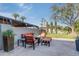 Well-appointed backyard oasis with orange outdoor seating centered around a fire pit creating an ideal space for entertaining at 345 W Gardenia Dr, Phoenix, AZ 85021