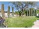 Manicured backyard showcases lush lawn, mature trees and well-manicured landscaping, creating a serene outdoor environment at 345 W Gardenia Dr, Phoenix, AZ 85021