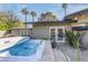 An outdoor jacuzzi, lush plants, and a mounted TV create a backyard oasis at 345 W Gardenia Dr, Phoenix, AZ 85021
