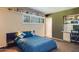 A blue comforter adorns the bed in this comfortable bedroom with large window at 345 W Gardenia Dr, Phoenix, AZ 85021