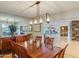 A dining room with wood table set, modern light fixture, and views to the living room at 345 W Gardenia Dr, Phoenix, AZ 85021