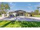 A modern home's exterior boasts a contemporary design, with a large driveway and well-manicured lawn at 345 W Gardenia Dr, Phoenix, AZ 85021