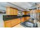 Well-equipped kitchen featuring custom cabinetry, black granite countertops, and stainless steel appliances at 345 W Gardenia Dr, Phoenix, AZ 85021