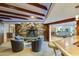 Open living room design with stone fireplace, bar, light wood floors and comfortable furniture at 345 W Gardenia Dr, Phoenix, AZ 85021