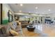 Spacious living room with a large sectional sofa, hardwood floors, and access to the patio at 345 W Gardenia Dr, Phoenix, AZ 85021