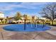 Community playground with various play structures set on a blue surface, perfect for outdoor fun at 3709 E Stiles Ln, Gilbert, AZ 85295