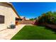 Large backyard with an outdoor grill, artificial turf, and a cozy fire pit, great for entertaining at 3899 S Chaparral Rd, Apache Junction, AZ 85119
