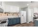 Renovated kitchen with white cabinets, granite countertops, and stainless steel appliances at 3899 S Chaparral Rd, Apache Junction, AZ 85119