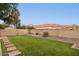 A backyard with grass, pavers, rock landscaping and a block wall at 3948 W Butler St, Chandler, AZ 85226