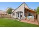 A backyard with grass, rock landscaping, an open patio and modern outdoor furniture at 3948 W Butler St, Chandler, AZ 85226