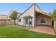 Exterior view of a backyard featuring grass, landscaping and an open patio area at 3948 W Butler St, Chandler, AZ 85226