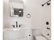 Modern bathroom with a white vanity, sleek fixtures, mirror and bathtub/shower combo at 3948 W Butler St, Chandler, AZ 85226