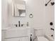 Modern bathroom with a marble countertop, an undermount sink, and black fixtures at 3948 W Butler St, Chandler, AZ 85226