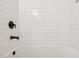 Clean bathroom featuring a tile wall, bathtub and modern fixtures at 3948 W Butler St, Chandler, AZ 85226