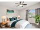 Nicely staged bedroom showcasing a ceiling fan, large window, and ample natural light at 3948 W Butler St, Chandler, AZ 85226