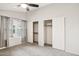 Bright bedroom featuring plush carpet, ceiling fan, window and a closet with sliding doors at 3948 W Butler St, Chandler, AZ 85226
