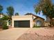 Charming home featuring a black garage door and desert landscaping at 3948 W Butler St, Chandler, AZ 85226