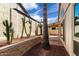 The enclosed backyard with brick accents features desert landscaping and partial covered patio at 448 E Wescott Dr, Phoenix, AZ 85024