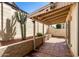 Charming backyard patio area with brick tiling, raised garden beds, and cacti landscaping at 448 E Wescott Dr, Phoenix, AZ 85024
